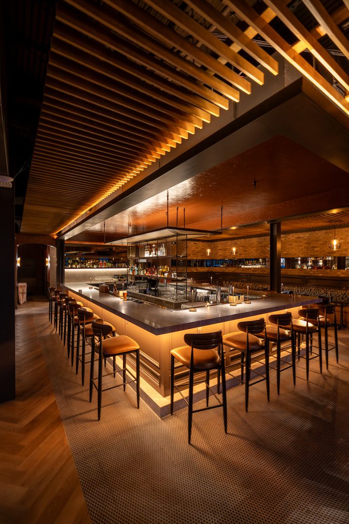 Bar with stools and warm wood ceiling